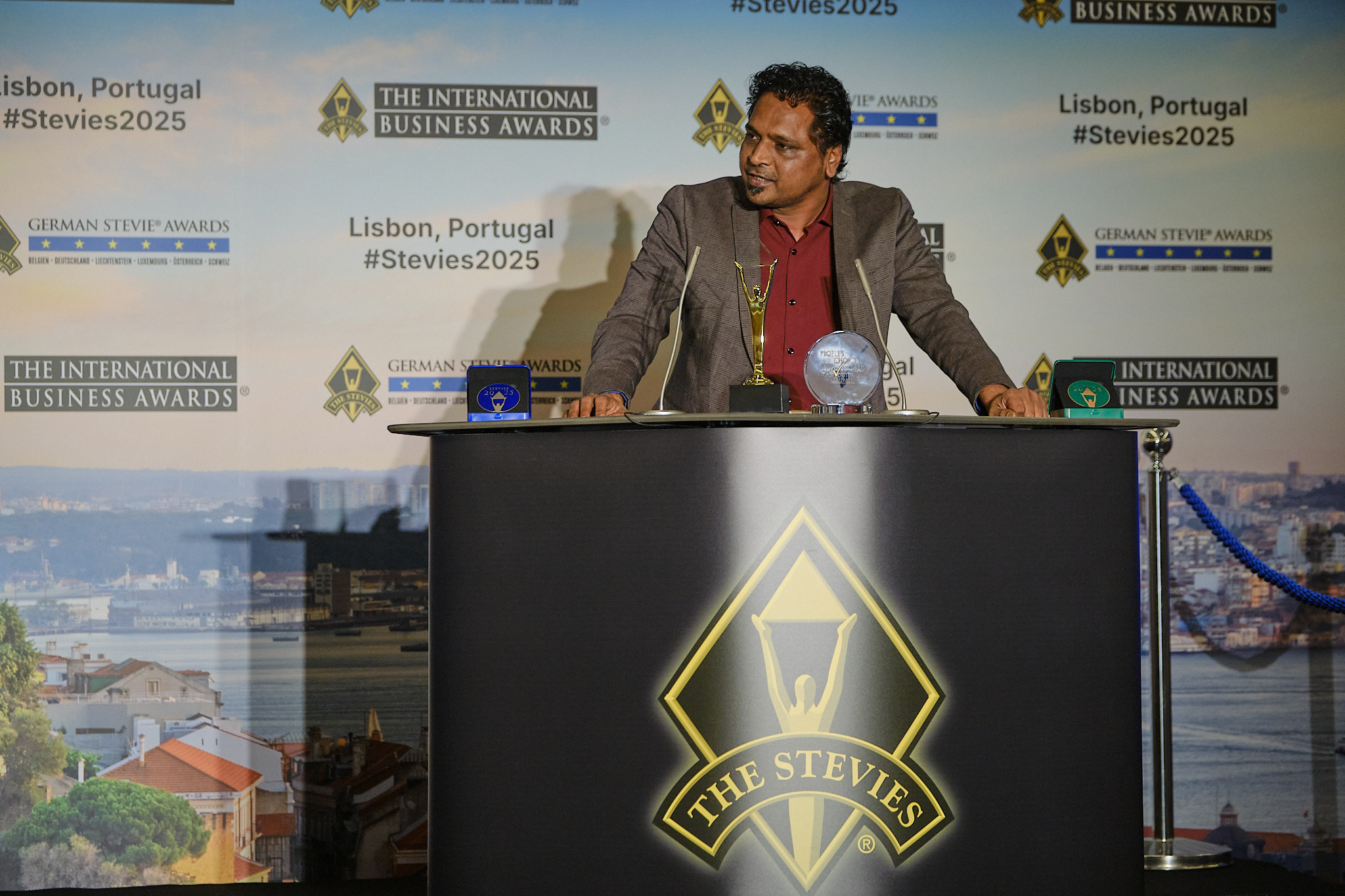 Chirag Patel delivering speech at Stevie Awards ceremony in Lisbon, Portugal 2025, representing Hidden Brains